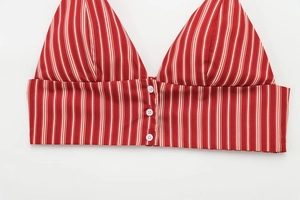 Detailed macro view of red and white striped bikini top featuring three white decorative buttons