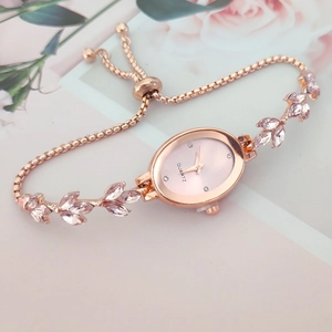 Rose gold wheat spike rhinestone watch with pink oval dial and adjustable leaf bracelet