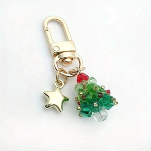 Detailed view of Christmas tree keychain with green crystal beads and gold star charm