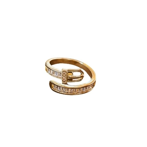 Gold plated belt buckle open ring with sparkling cubic zirconia on white background