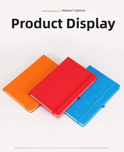 Detail view of hardcover notebooks in orange, red, and blue with elastic closure straps