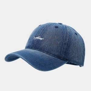 Detail view of navy denim baseball cap featuring white Asher script letter embroidery