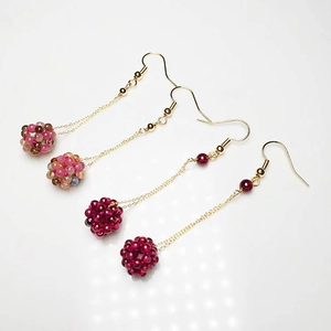 Detail of 14K gold plated long pull-through earrings with handmade crystal bead balls
