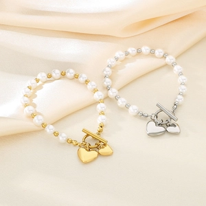 Elegant pearl bracelets with heart pendants and OT buckle in gold and silver finish