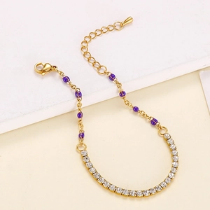 Detailed view of golden link bracelet with purple enamel beads and sparkling rhinestones