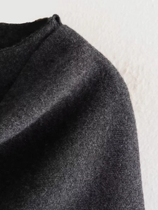 Macro detail of high-quality dark grey knit fabric with a soft cashmere-like texture
