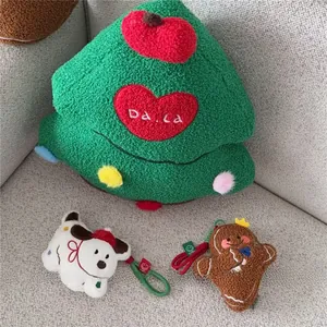 Detail of Christmas tree plush pillow with cute gingerbread man and puppy charms