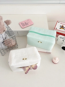 Pastel waffle-weave makeup bags in mint and white with silk flower accents