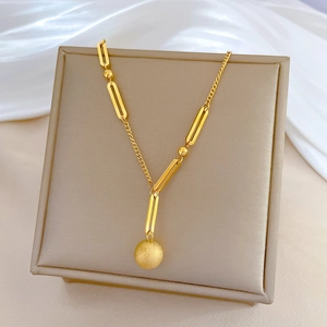 Minimalist 18K gold plated titanium steel necklace with a matte ball pendant on silk