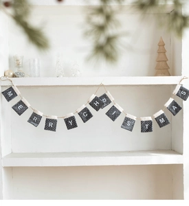 Close-up of Merry Christmas felt stocking banner with soft white faux fur trim decor