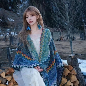 Close-up of colorful wave pattern knit poncho with tassel trim for vacation