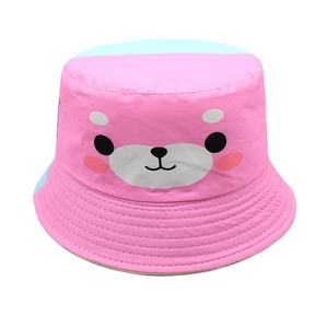 Close-up of pink cotton sun hat featuring a cute bear print and blue contrast stitching