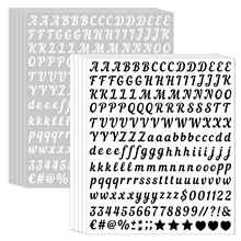 Detail showing multiple sheets of black and white alphabet stickers for scrapbooking