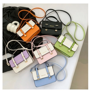 Flat lay of small messenger bags in orange black green purple pink and blue colors