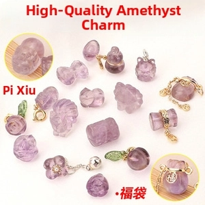 Macro view of carved purple amethyst charms featuring lucky symbols and gold accents
