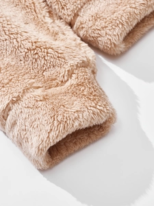Close-up of thick beige fleece jacket cuff showing premium soft textured material