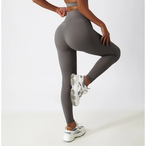 Close-up of high-waisted gray yoga pants with butt-lifting seams and elastic fabric