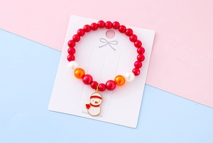 Close-up of a kids' Christmas beaded bracelet with a cute enamel snowman charm