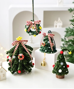 Detailed view of handmade plush Christmas trees and wreaths with bells and ribbons