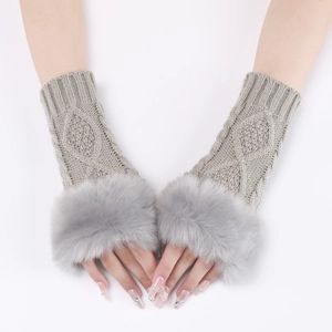 Detailed view of grey cable knit arm warmers with faux fur trim on a white background