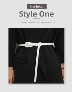 White slim leather waist belt tied in a minimalist knot over a stylish black blazer