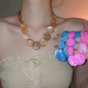 Detail of round shell bead necklaces in blue, pink and brown with adjustable lobster clasp