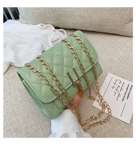 Detail view of mint green quilted PU leather crossbody bag with golden chain and Y-lock closure