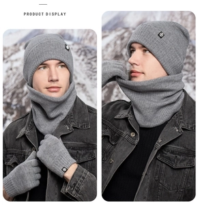 Detailed view of grey winter knit hat, scarf and gloves set with thick fleece lining