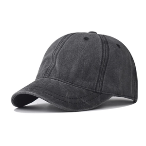 Detail of charcoal grey washed cotton short brim baseball cap with vintage distressed texture