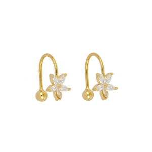 Close-up of golden flower earrings set with clear zircon stones on a white background