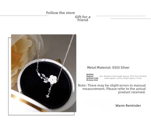 Detail of S925 silver necklace with carved shell flower pendant and cubic zirconia