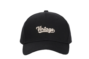 Close-up of white Vintage embroidery on a black cotton canvas baseball cap