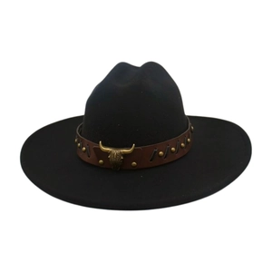 Detail of western cowboy hat featuring a leather band with vintage bull head metal ornament
