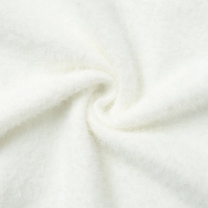 Macro detail of soft white faux fur fabric showing plush texture and fleece thickness