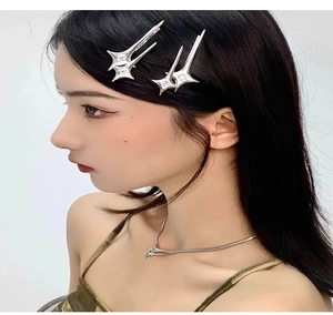 Model wearing silver Y2K star hair clips and matching necklace on a white background