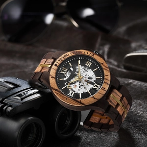 Detail shot of men's wood mechanical watch with hollow movement and zebra wood band