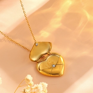 Detailed macro view of gold heart locket opening with engraved I Love You message inside