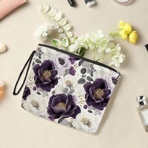 Elegant floral cosmetic bag with purple peonies, black zipper, and convenient wrist strap