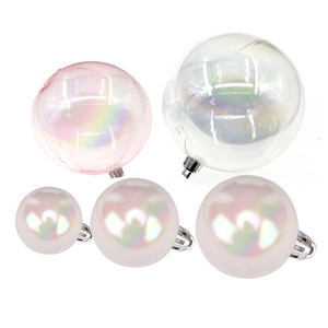 Iridescent gold and silver cake decoration balls with hooks on white background