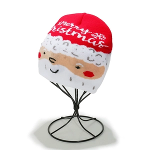 Detail of knitted Christmas hat featuring snowman pattern and Merry Christmas text
