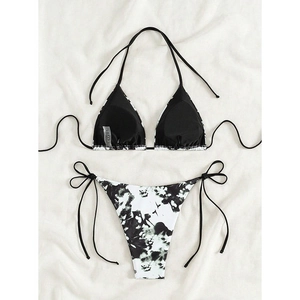 Detail of tie-side bikini set with black and white marble print on soft textured fabric
