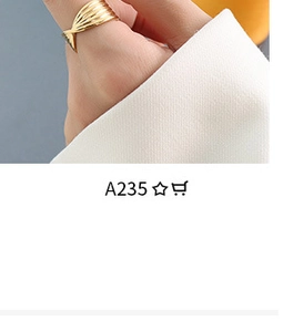 Macro shot of 18k gold plated fan-shaped ring with textured pleated metal details