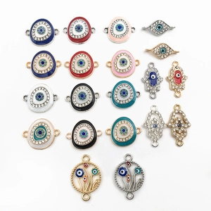Detailed macro view of colorful enamel and rhinestone evil eye jewelry pendants charms