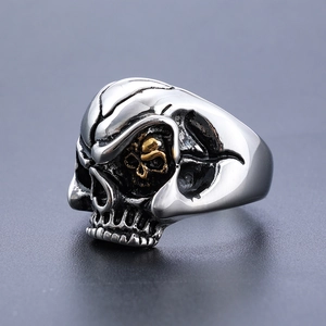 Vintage stainless steel double skull ring with gold accents in a gothic punk style