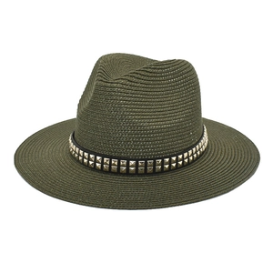 Detail of dark olive straw fedora featuring a black band with double rows of gold studs