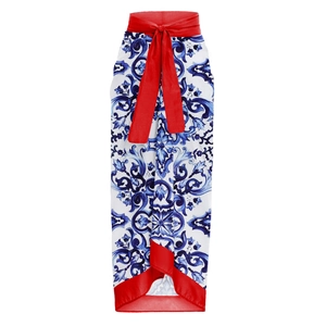 Detail view of Mediterranean print maxi dress with red silk bow belt and contrasting hem