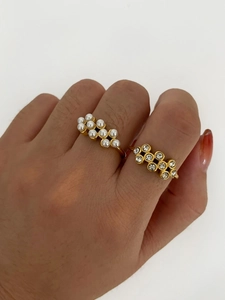 Macro detail of 18k gold plated honeycomb rings with faux pearls and sparkling cubic zirconia