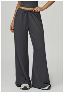 Detail of high-waist dark grey wide-leg trousers with elastic drawstring waistband