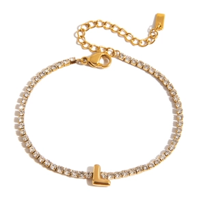 Detailed shot of golden tennis bracelet with letter L pendant and cubic zirconia