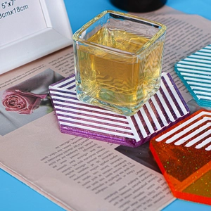 Macro detail of hexagonal resin coasters with geometric lines and subtle glitter finish